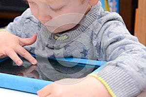Child using a tablet touch screen device