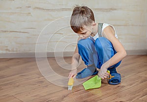 Child using toy broom and dustpan