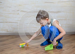 Child using toy broom and dustpan