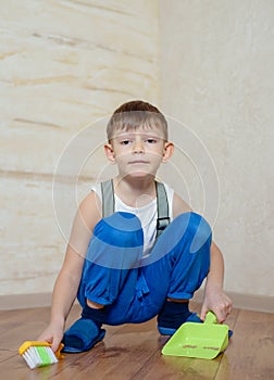 Child using toy broom and dustpan