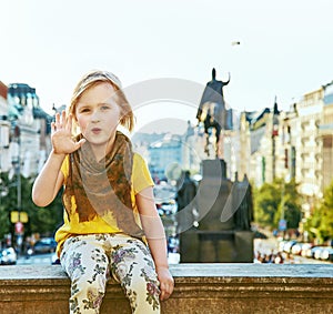 Child on Vaclavske namesti in Prague Czech Republic handwaving photo