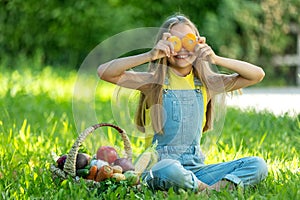 Child with vegetables. Happy little girl holding vegetables in her hands.