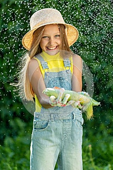 Child with vegetables. Happy little girl holding vegetables in her hands.