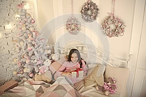 Child waiting christmas in bedroom. Kid lay in bed relaxing. Home is the best place in the world. Girl little kid