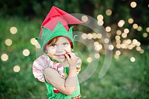 Child waiting for a Christmas in wood in juli. portrait of little children near christmas tree. girl decorating christmas tree