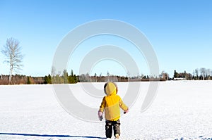 Child waking on a snowy field