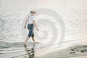 Child walking along the beach