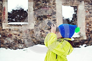Child walking around old castle. Little boy discovery intresting things during using monocular
