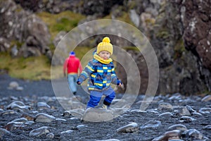 Child, walking on the beach in beautiful nature in Snaefellsjokull National Park in Iceland