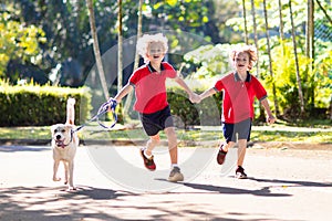 Child walking dog. Kids and puppy. Boy and pet