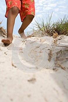 Child walking down dune