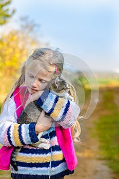 Child walking with his cute cat alone