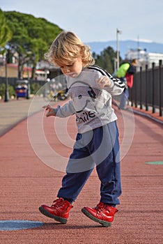 Child walking on the street. Embankment of the Olympic Park in Sochi, Adler, Russia. Travel