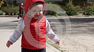 The child walks alone on the sidewalk and cries.