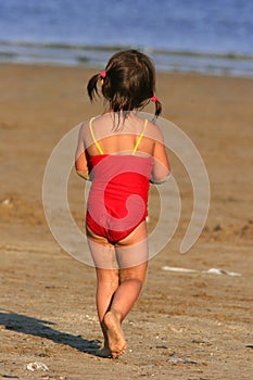 Child Wandering Towards The Sea photo