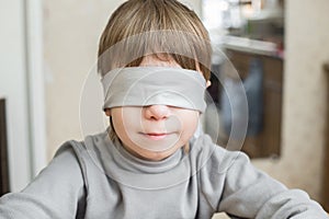 The child was blindfolded at home.