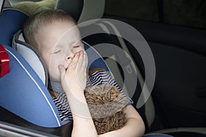 The child was rocked in a car seat. The boy suffers from kinetosis and motion sickness. The concept of motion sickness and