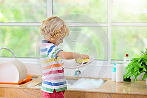 Child washing dishes