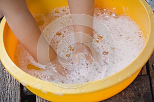 Child washing hands with soap to prevent virus and bacteria for corona virus covid19 protection