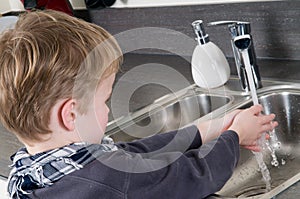 Child washing his hands