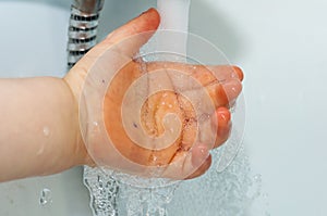 Child washing his hands