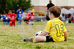 Child watching youth soccer game