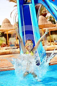 Child on water slide at aquapark.