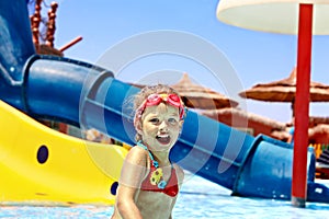 Child on water slide at aquapark.