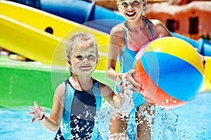 Child on water slide at aquapark.