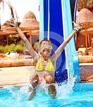 Child on water slide at aquapark.