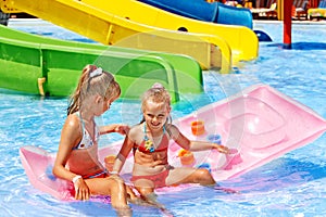 Child on water slide at aquapark.