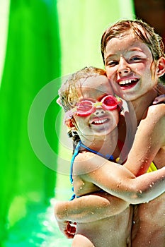 Child on water slide at aquapark.