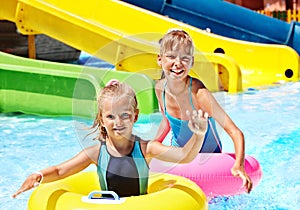 Child on water slide at aquapark.