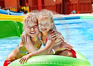 Child on water slide at aquapark.