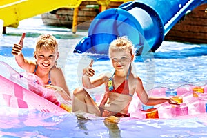 Child on water slide at aquapark.