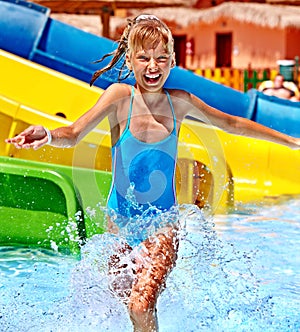 Child on water slide at aquapark.