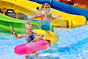 Child on water slide at aquapark.