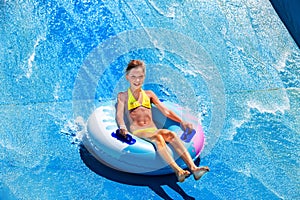 Child on water slide at aquapark