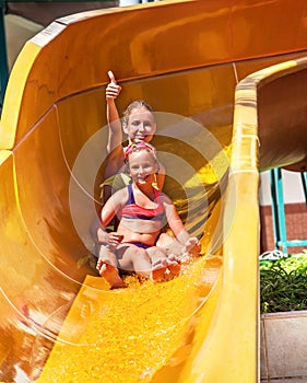 Child on water slide at aquapark.