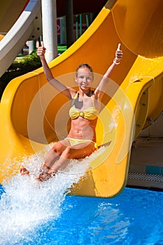 Child on water slide in aquapark.