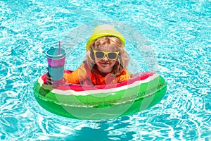 Child water toys. Children play in tropical resort. Happy kid playing with colorful swim ring in swimming pool on summer