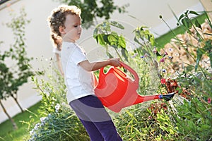 Child with watering can at gardening