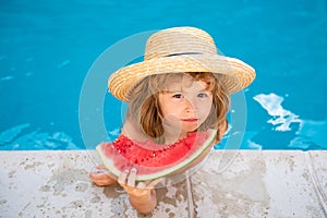 Child with watermelon in pool outdoor. Kid having fun in swimming pool. Kids summer vacation and healthy eating concept.