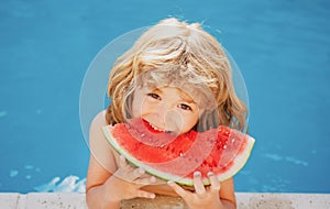 Child with watermelon in pool outdoor. Kid having fun in swimming pool. Kids summer vacation and healthy eating concept.