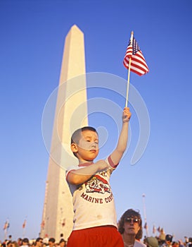 Child waving a miniature American flag