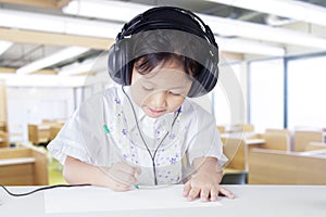 Child wearing earphones in listening lesson