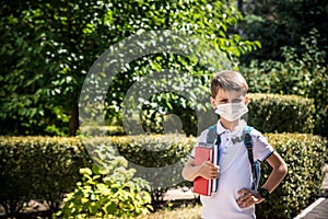 Child wearing face mask going at reopen school after covid-19 quarantine and lockdown. It is new normal for protection and