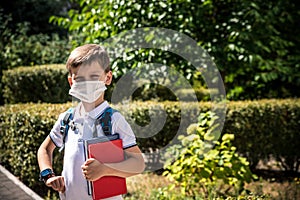 Child wearing face mask going at reopen school after covid-19 quarantine and lockdown. It is new normal for protection and