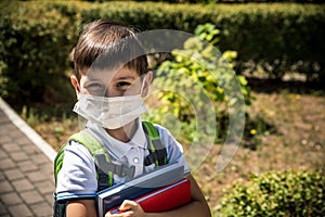 Child wearing face mask going at reopen school after covid-19 quarantine and lockdown. It is new normal for protection and