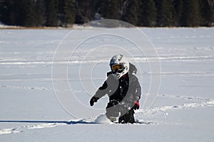 Child Wearing an OHV Stepping Through Deep Snow photo